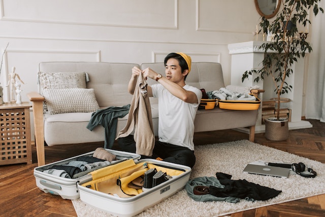 Man packing a suit in a suitcase