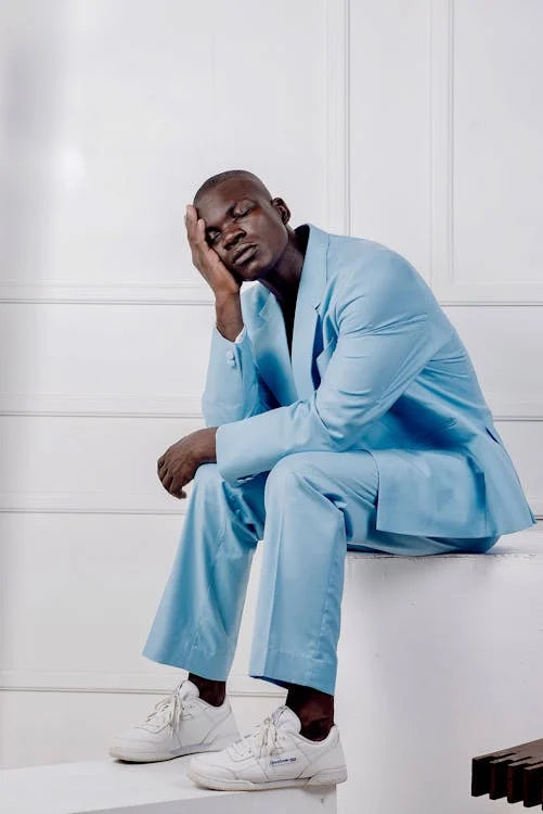 suit with sneakers: man wearing blue suite white sneakers