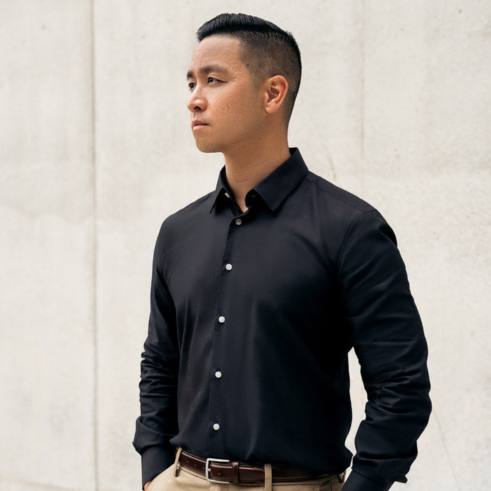 man wearing grey button up dress shirt with chino pants and a dark brown belt