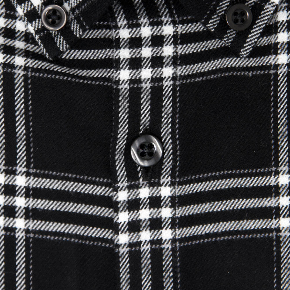 closeup of mens button on a mens black and white flannel