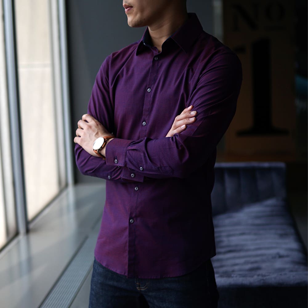 man wearing plum dress shirt in city