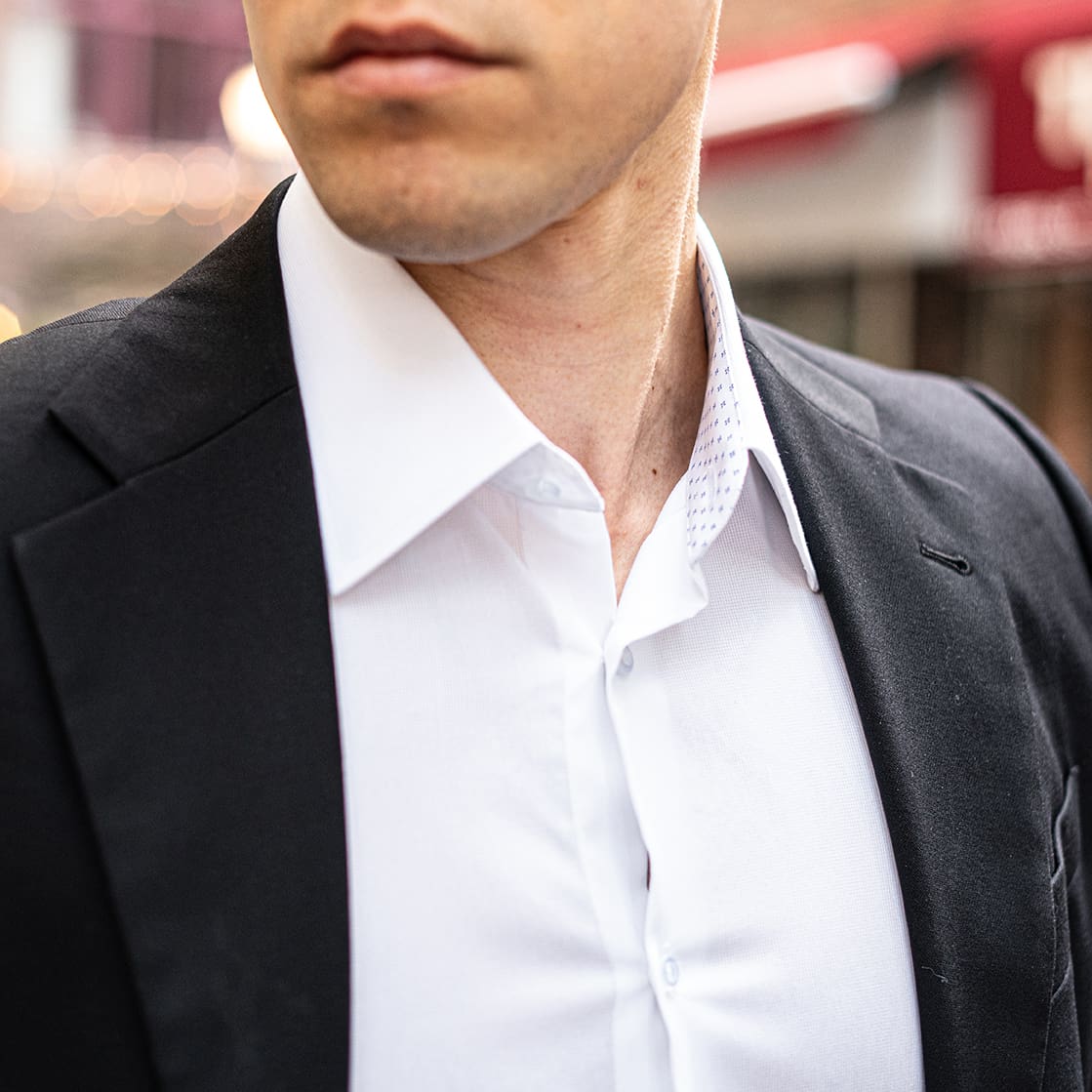white collared shirt with black suit jacket man with coffee in city Slim Fit White Collared Speckled Dress Shirt | Long Sleeve Button Up