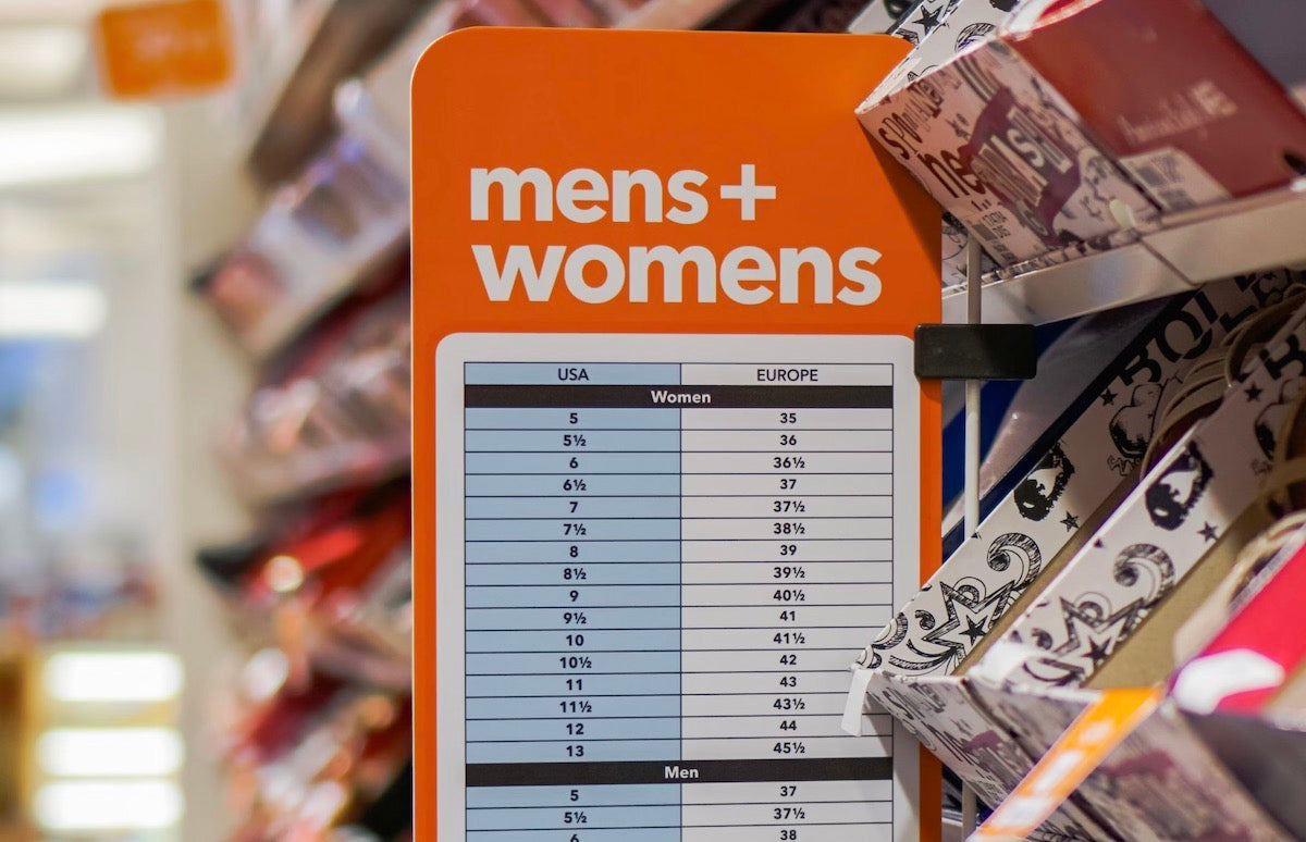 men's and women's shoe size conversion chart on display in shoe store