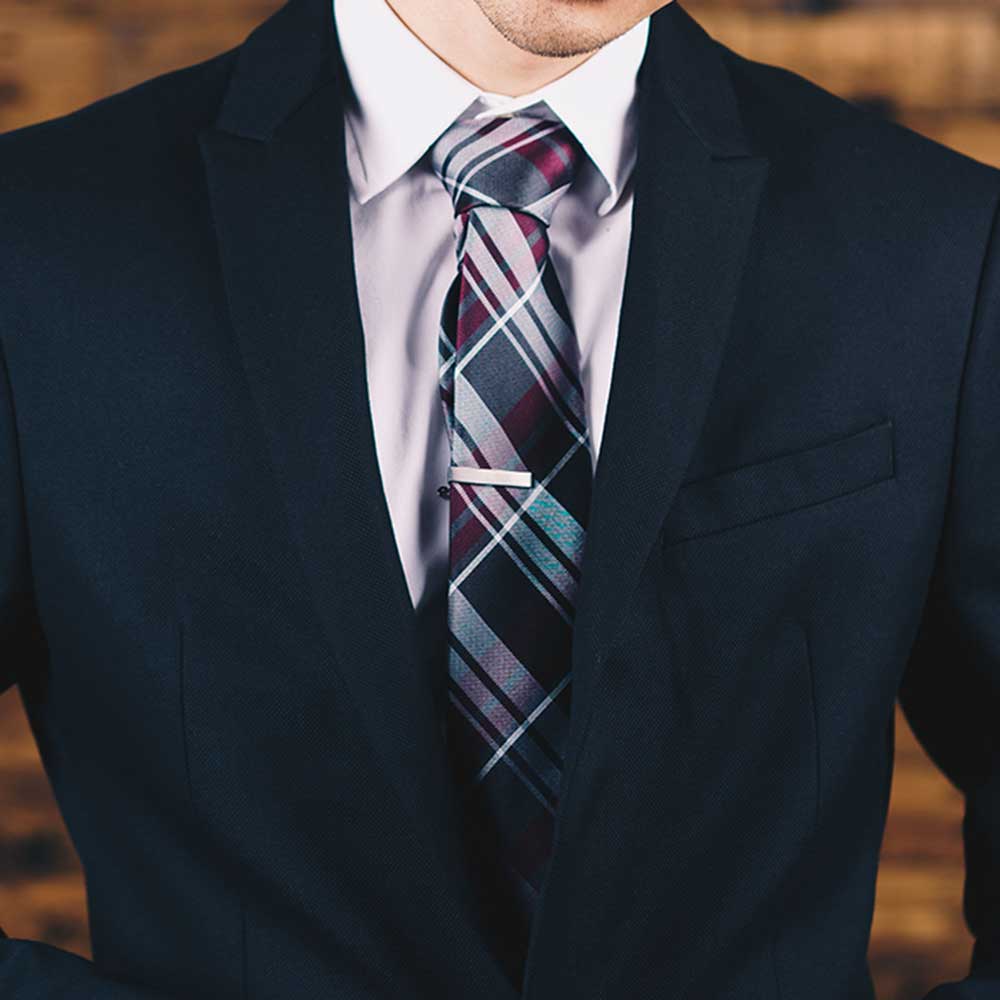 man wearing navy suit and tie for formal dress code
