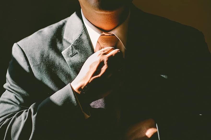 Man adjusting his tie for job interview