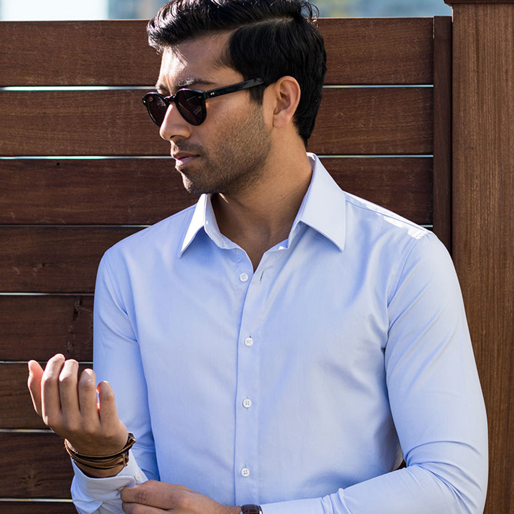shorten dress shirt sleeves: image of man adjusting shirt sleeves