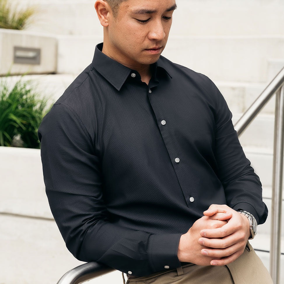 dark grey dress shirt on white collar professional wearing watch
