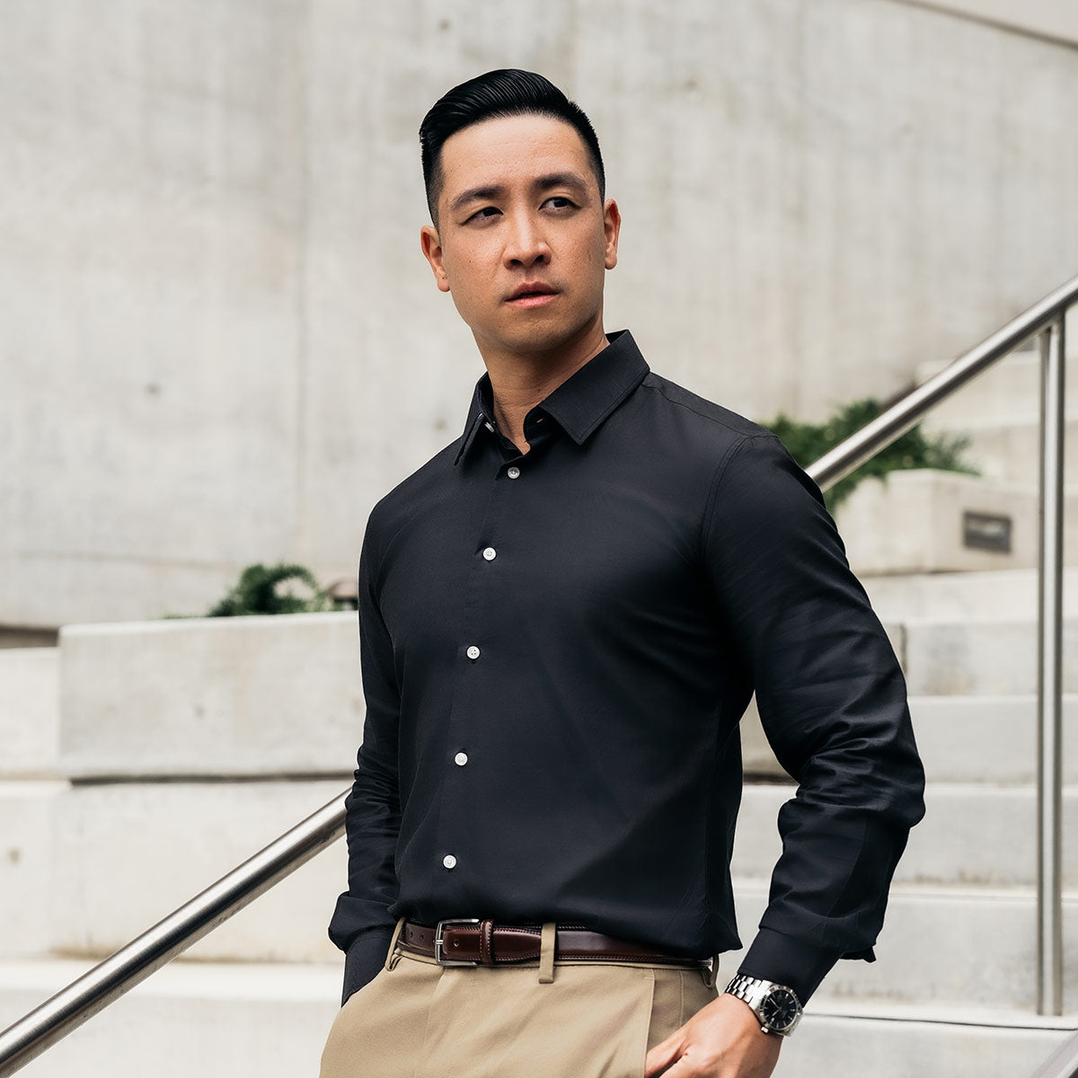 men's dark grey dress shirt on male model walking down city