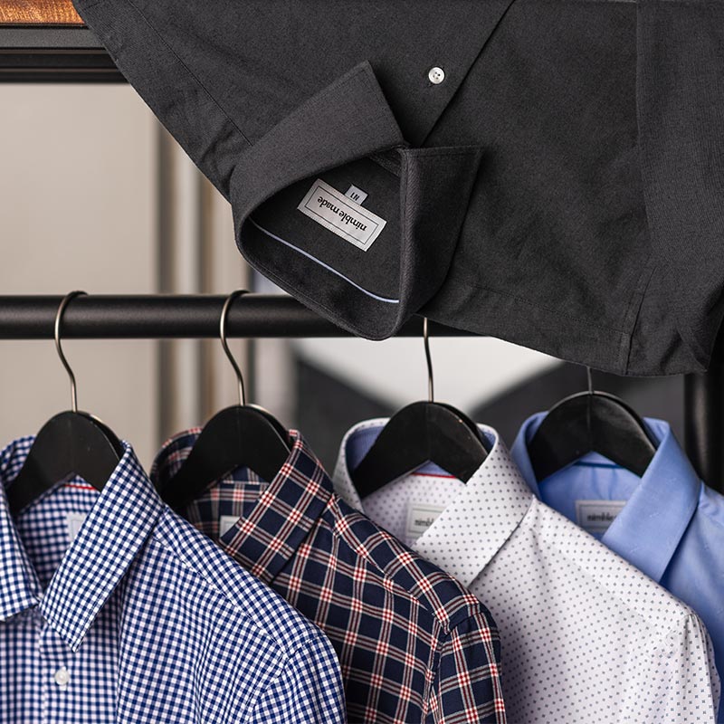 mens slim fit dress shirt collection hanging on rack lifestyle shot