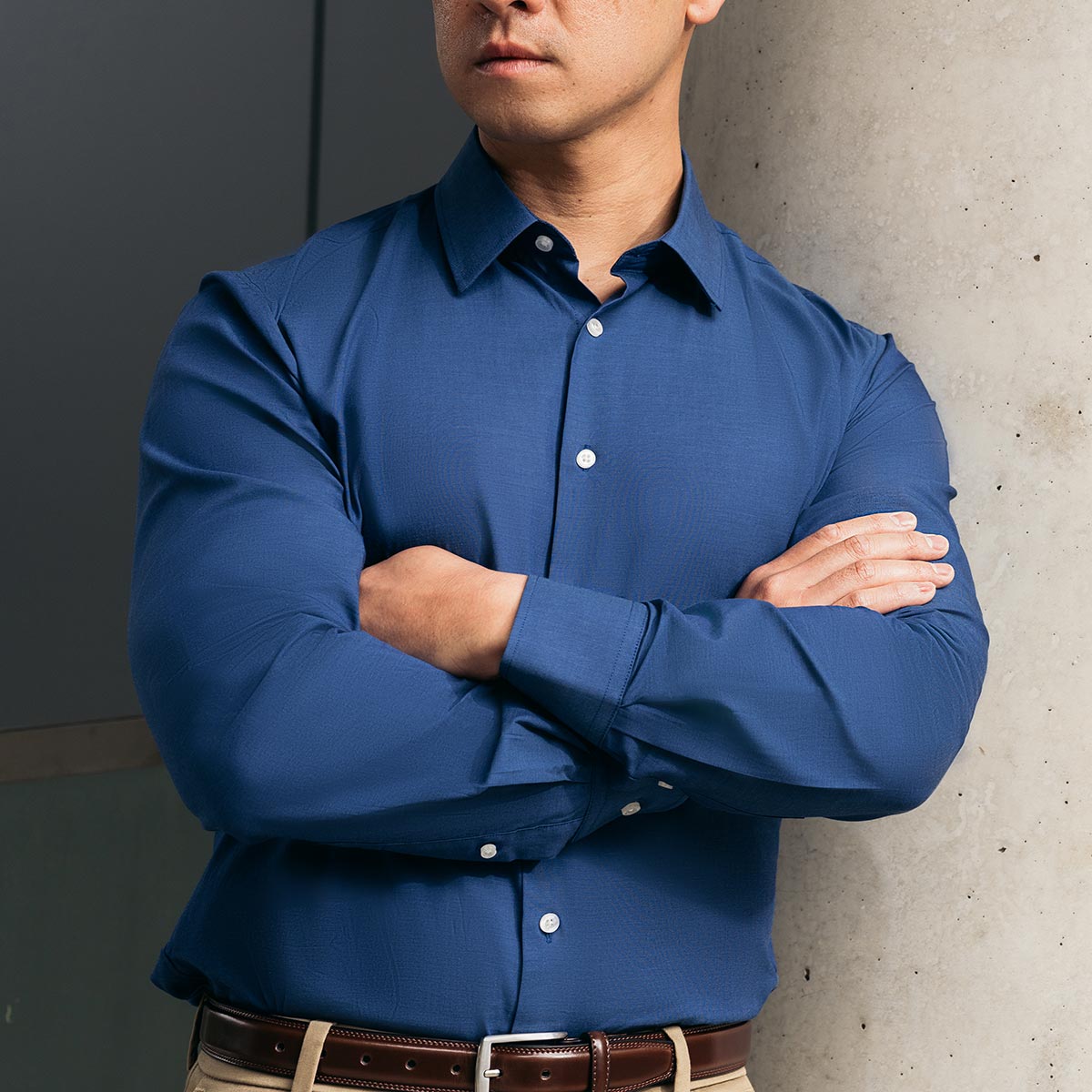 navy blue collar shirt on man wearing chino pants and brown belt