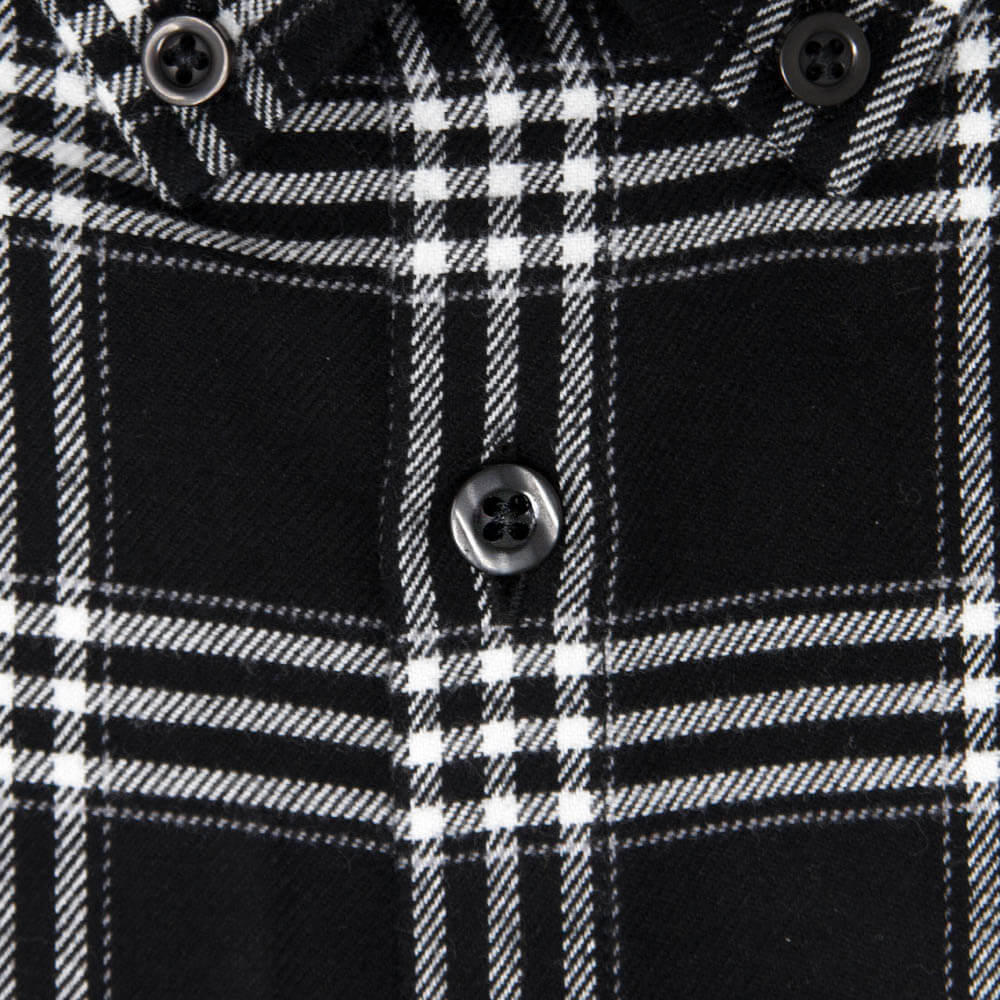 closeup of mens button on a mens black and white flannel