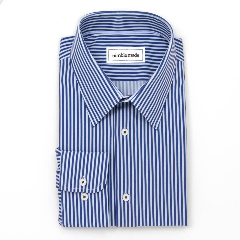 blue and white dress shirt folded on a white background