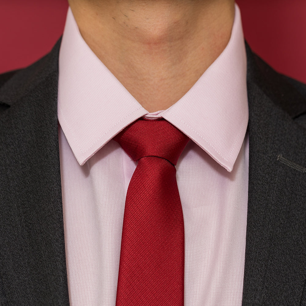 pink shirt red tie and dark gray charcoal suit jacket