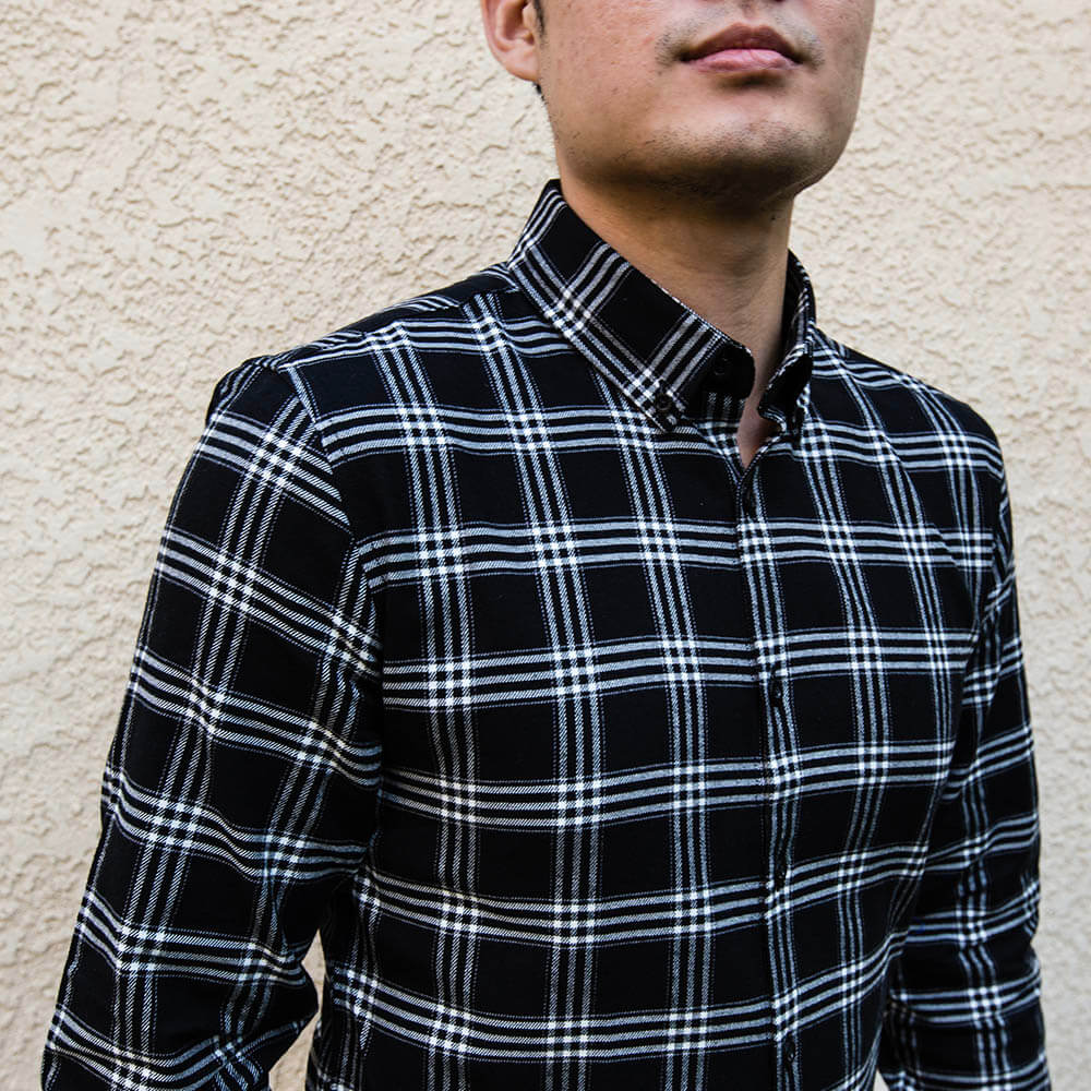 man wearing black and white flannel button down shirt