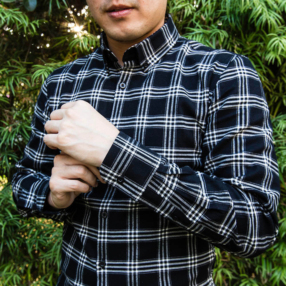 showcasing black and white flannel fit on male model