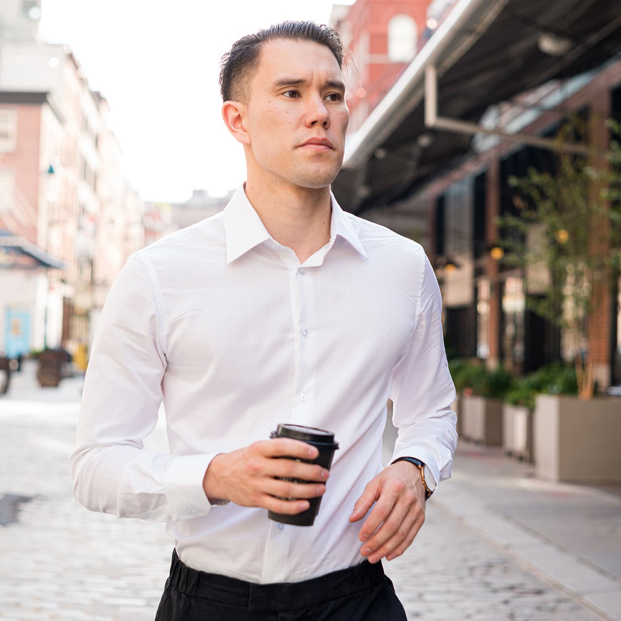 man with coffee in city wearing white button up collared dress shirt for men